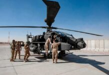 Poland Pushes For A Bigger American Presence Soldiers inspect a military attack helicopter on a tarmac