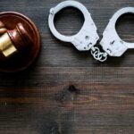 Prison Sentence Follows Plot to Kill Treasury Chief Gavel and handcuffs on wooden table