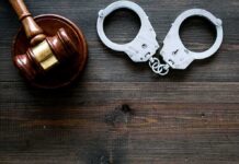 Prison Sentence Follows Plot to Kill Treasury Chief Gavel and handcuffs on wooden table