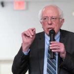 Elderly man speaking into a microphone
