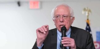 Elderly man speaking into a microphone