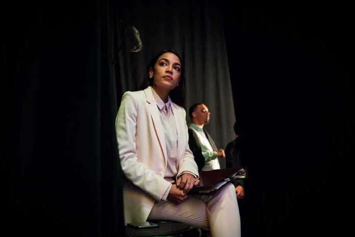 shutterstock_1398680387 Woman in a white suit sitting backstage with a folder