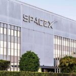 SpaceX headquarters exterior with large logo and windows