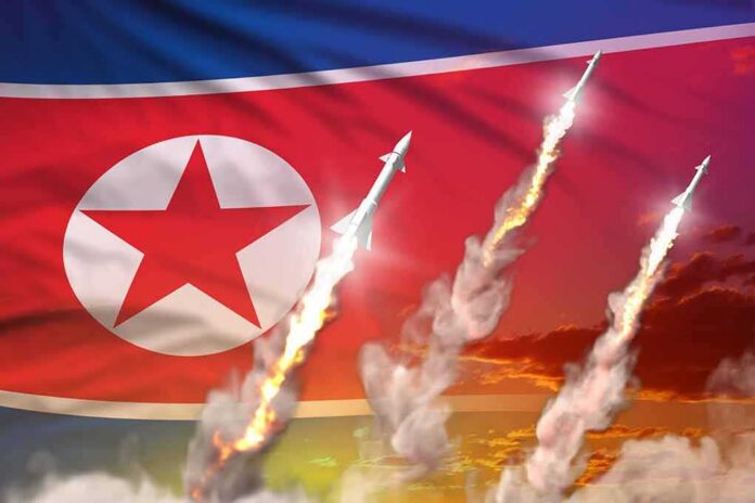 shutterstock_1894406545 North Korean flag with missiles launching and smoke trails