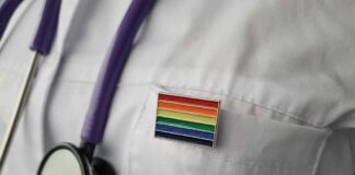 stethoscope on white lab coat with rainbow pin