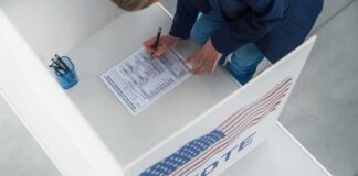 Voter filling out a ballot in a private voting booth
