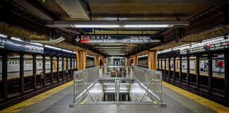 Subway platform with stairwell and tracks on both sides