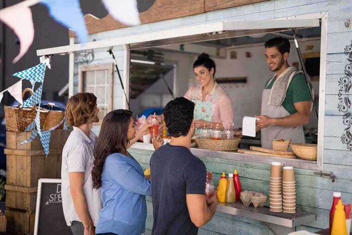 shutterstock_670837651 food truck staff serve drinks to customers at window