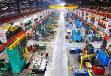 Did Cheap Imports Cost America Too Much? Aerial view of a large industrial workshop filled with various machinery and equipment