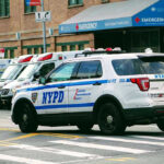 Serial Attacks Minutes Apart Rattle Brooklyn Police car and ambulances outside emergency room entrance.