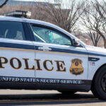 White House Lockdown: Gunfire Erupts Near Trump United States Secret Service police car on roadside.