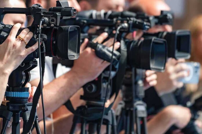 television cameras on tripods at a media event