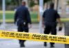 Armed Intruder Enters School, Children Escape Unharmed Police officers walking past caution tape at a crime scene