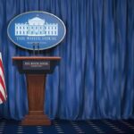 Trump’s Defense Push Divides Fiscal Conservatives White House press briefing podium with U.S. flag and blue curtain
