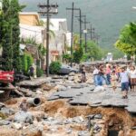 Three Generations Gone After Missile Strike Residents walk along a heavily damaged street after a disaster