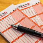 Lottery Winner Arrested For Fifth Time! Powerball lottery play slips with a black pen