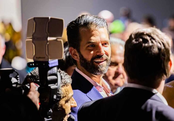 shutterstock_1314219836 man with beard in suit speaking to people at crowded event