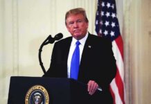 Trump Corrals Musk, Zuck – What Did They Sign? man at podium with microphone and US flag