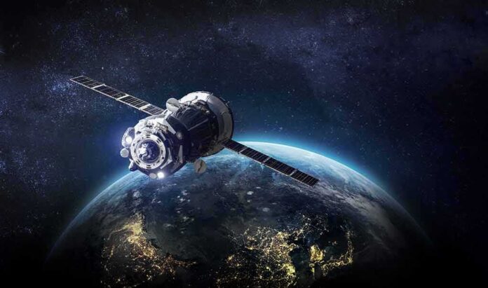 shutterstock_1371521279 Satellite orbiting Earth over night side