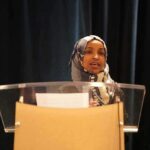 A Deportation Call Just Reignited An Old Controversy Woman in hijab speaking at a podium