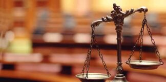 bronze balance scales on a courtroom desk