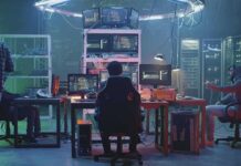 People working at computers in a dim server room