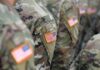 A New American Base Is Getting Much Closer U.S. flag patches on camouflage military uniforms