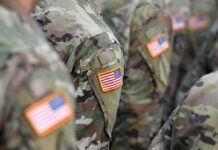 A New American Base Is Getting Much Closer U.S. flag patches on camouflage military uniforms