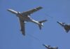 Aerial refueling with a large tanker and two fighter jets in flight