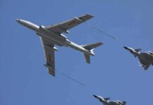 Aerial refueling with a large tanker and two fighter jets in flight