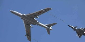 Aerial refueling with a large tanker and two fighter jets in flight