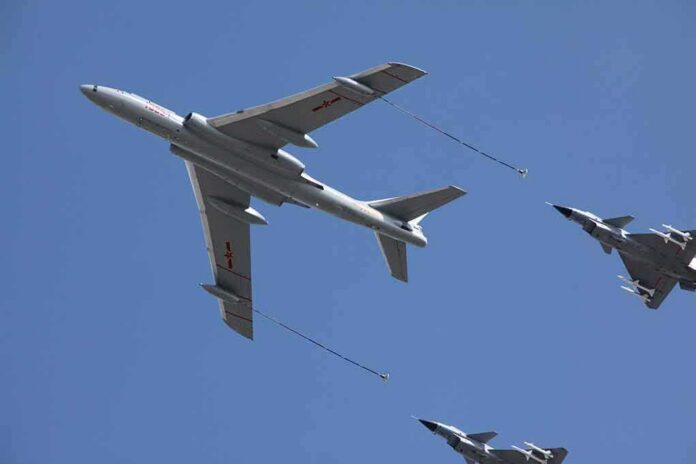 Aerial refueling with a large tanker and two fighter jets in flight