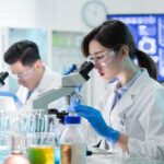 The Lab-Dog Pipeline Just Landed in Congress Scientist using a microscope in a modern laboratory