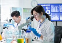 The Lab-Dog Pipeline Just Landed in Congress Scientist using a microscope in a modern laboratory