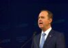 A Trump Rival Just Found Common Ground Man in suit speaking at a podium