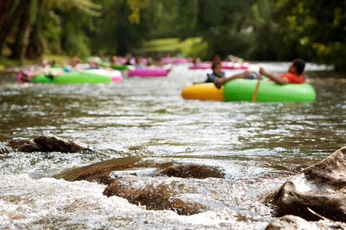 People floating on colorful inner tubes in a river