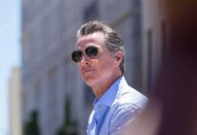 California Says No. The Feds Say Watch Us Gavin Newsom wearing sunglasses outdoors
