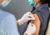 Healthcare worker administers vaccine to patient’s upper arm