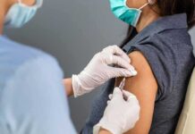 Healthcare worker administers vaccine to patient’s upper arm