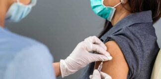 Healthcare worker administers vaccine to patient’s upper arm