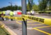 Shots Fired, Questions Mount in Immigration Encounter Police tape cordons off a street scene