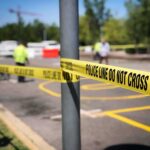 Shots Fired, Questions Mount in Immigration Encounter Police tape cordons off a street scene