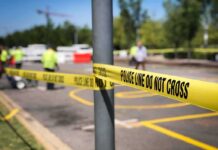 Shots Fired, Questions Mount in Immigration Encounter Police tape cordons off a street scene