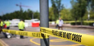 Police tape cordons off a street scene