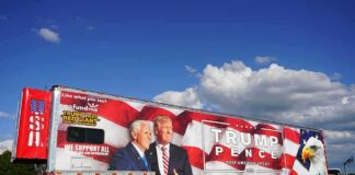 Semi trailer with large political campaign wrap beside a road