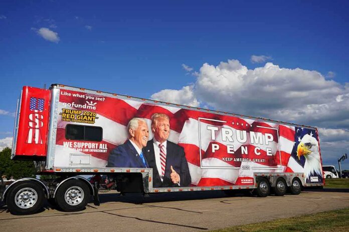 shutterstock_1797807046 Semi trailer with large political campaign wrap beside a road