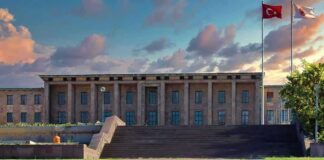Government building with columns and Turkish flag at sunset
