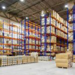 Ukraine’s Drones Keep Hammering Russia’s Retail Giant Warehouse aisles with tall blue and orange pallet racks filled with boxes
