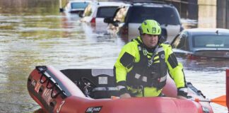 Rescue worker in an inflatable boat during urban flooding