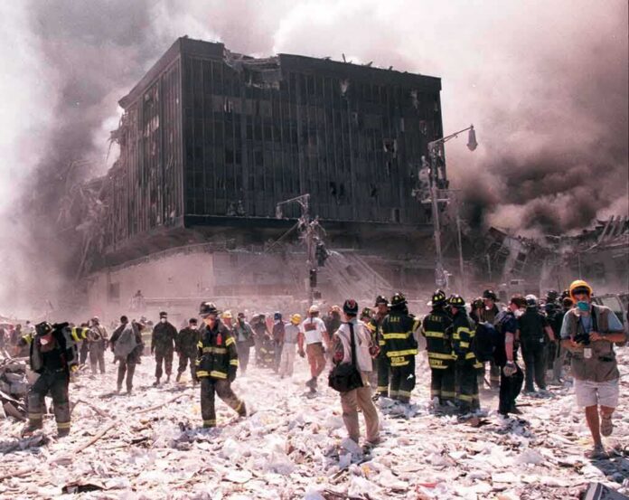 shutterstock_20814040 First responders amid debris near a heavily damaged building